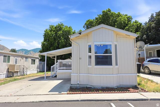 1525 South 400 East, Unit 13 Springville, UT 84663 - Photo 9 of 32 Beige siding exterior with a bay window, covered porch, and carport