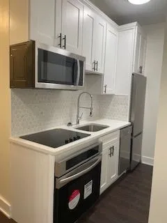 a kitchen with a stove and a microwave