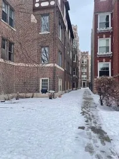 a brick building with a bench in front of it