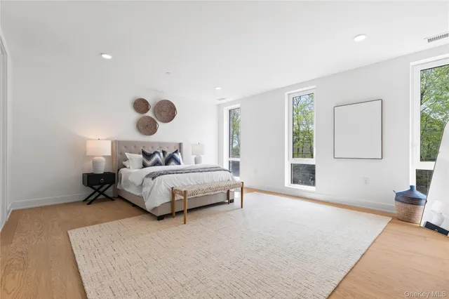 a bedroom with a large bed and a large window