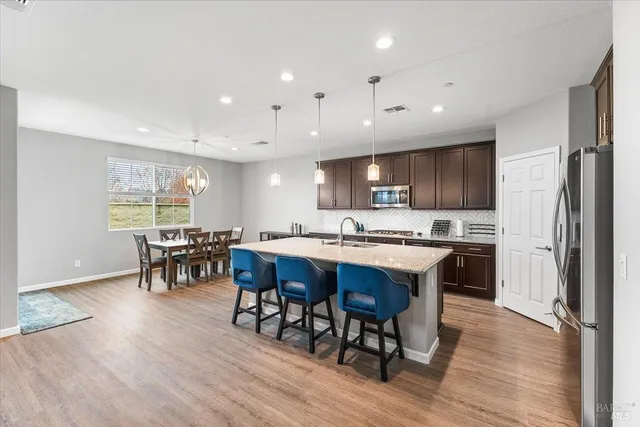 a large kitchen with a table and chairs