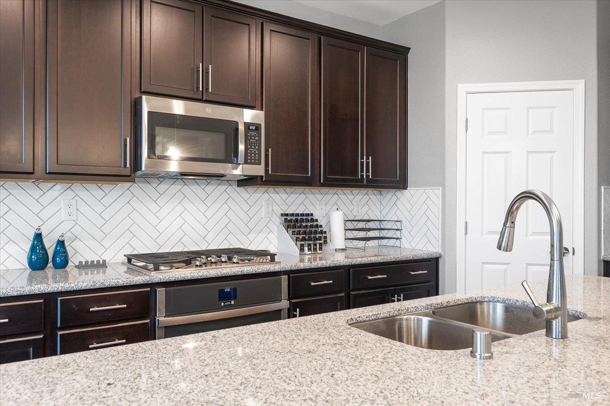 2180 Karen Place Rohnert Park, CA 94928 - Photo 14 of 48 a kitchen with stainless steel appliances granite countertop a stove a sink and a microwave