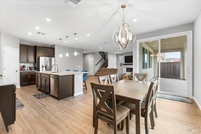 a view of a dining room with furniture wooden floor and chandelier