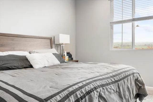 a bedroom with a bed and window