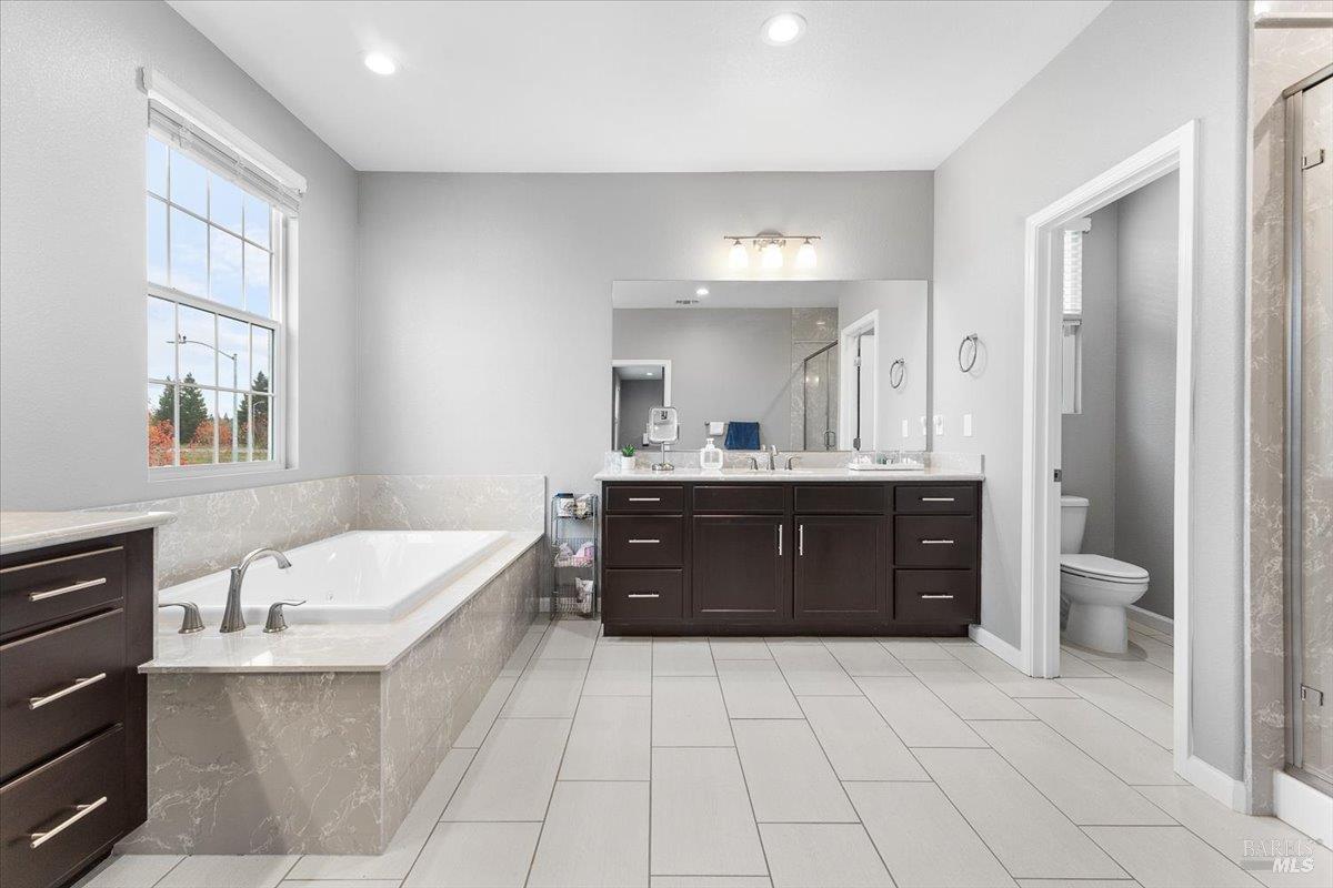 2180 Karen Place Rohnert Park, CA 94928 - Photo 27 of 48 a bathroom with a granite countertop double vanity sink a mirror and a bathtub