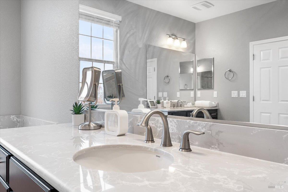 2180 Karen Place Rohnert Park, CA 94928 - Photo 30 of 48 a bathroom with a double vanity sink window and a mirror