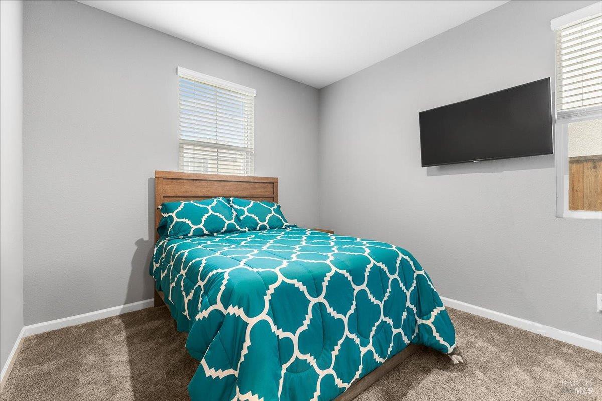 2180 Karen Place Rohnert Park, CA 94928 - Photo 35 of 48 a bed sitting in a bedroom next to a window with kitchen view