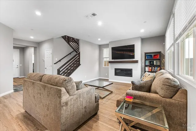 a living room with furniture flat screen tv and a fireplace