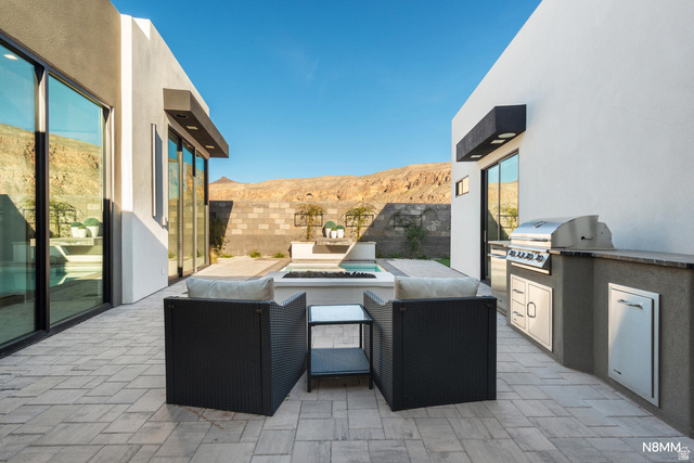 3607 South Cypress Pt Road Hurricane, UT 84737 - Photo 56 of 59 Fenced backyard with a mountain view, a patio area, a fire pit, and exterior kitchen