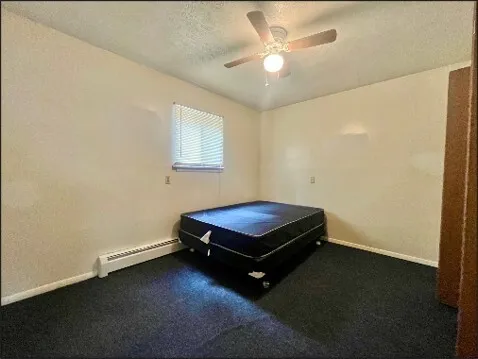 a room with pool table and a ceiling fan