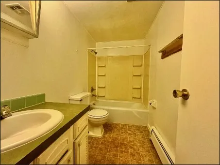 a bedroom with a bed and a chair