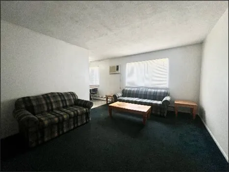 a kitchen with stainless steel appliances a refrigerator a sink and white cabinets