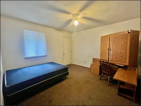 a living room with hard wood floors and a ceiling fan