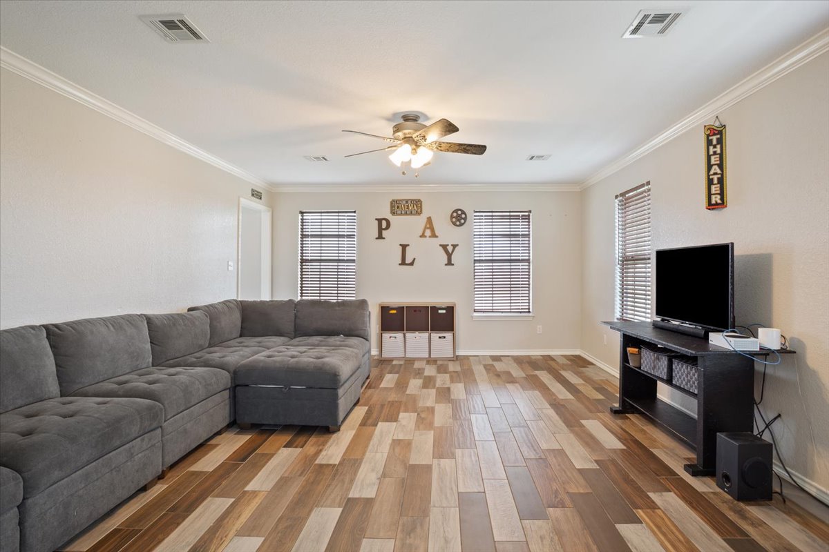 8600 Five Wells Road Rogers, TX 76569 - Photo 8 of 40 Living area featuring light wood-style floors, ornamental molding, and a ceiling fan