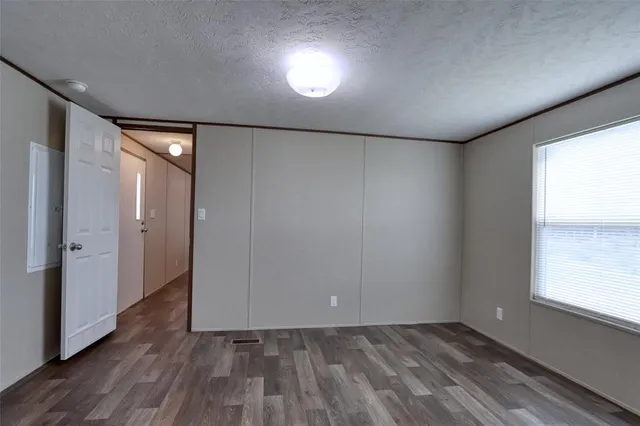 a kitchen with granite countertop a refrigerator and a stove top oven