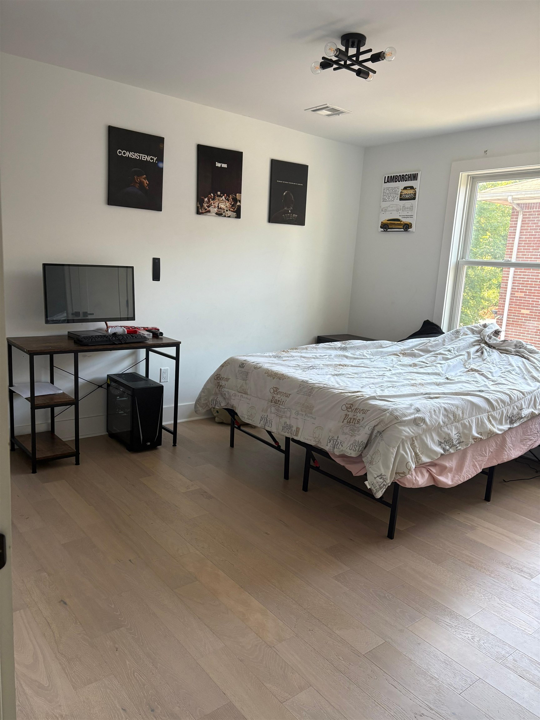 203 A Queen Anne Road Bogota, NJ 07603 - Photo 2 of 3 a bedroom with a bed and a flat screen tv