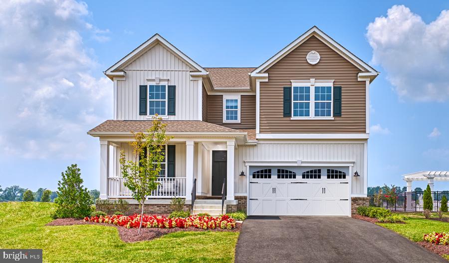 Bluestem Way, Unit CORONADO Fredericksburg, VA 22407 - Photo 1 of 37 a front view of a house with a yard and garage