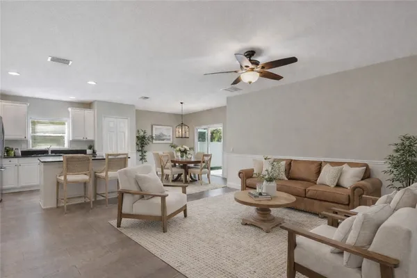 a living room with furniture a rug and white walls