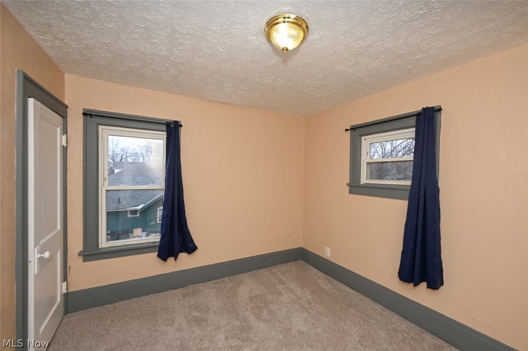 77 West Mildred Avenue Akron, OH 44310 - Photo 22 of 40 Carpeted empty room with a textured ceiling and plenty of natural light
