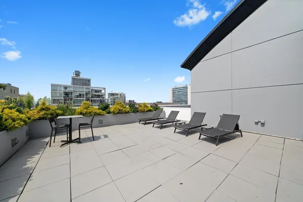 a terrace with outdoor seating and city view