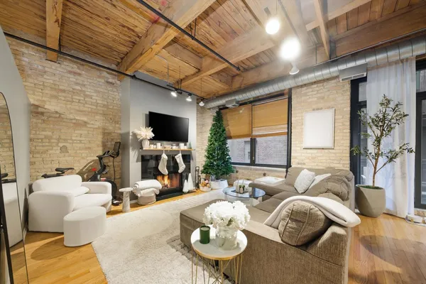 a living room with furniture flat screen tv and a fireplace