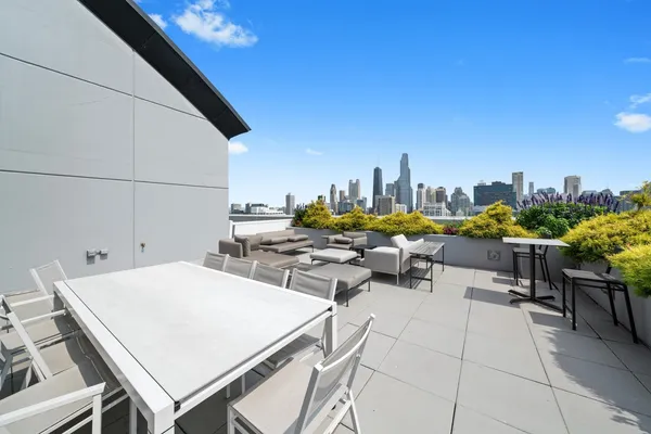 a view of a patio with a table and chairs