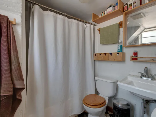 a white toilet sitting next to a bathroom sink
