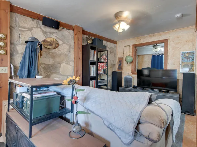 a bedroom with bed and a chandelier