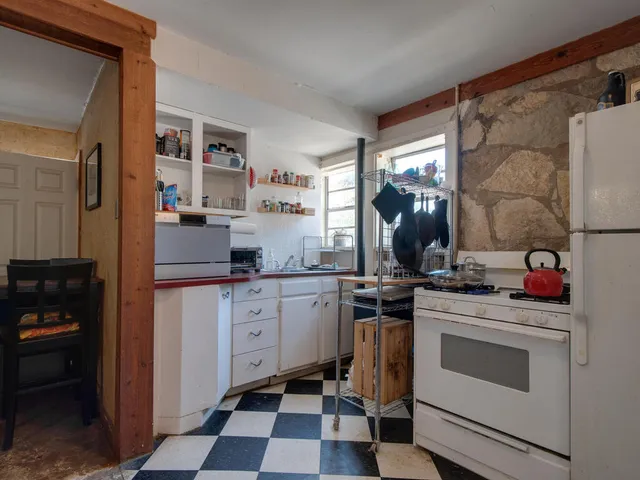 a kitchen with a stove oven and sink