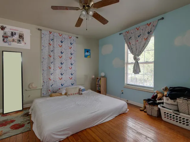 a bedroom with a bed dresser and a window