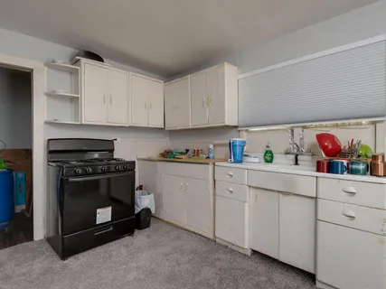 a kitchen with cabinets and appliances