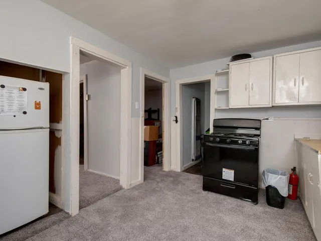 a kitchen with refrigerator and cabinets