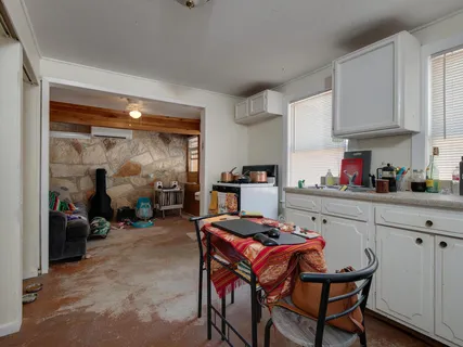 a kitchen with a table chairs and a refrigerator
