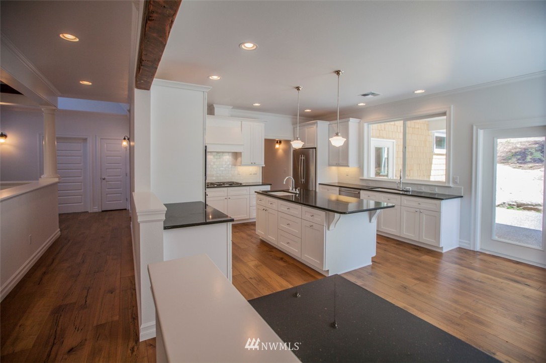 474 Whitecap Road Bellingham, WA 98229 - Photo 11 of 13 a large kitchen with kitchen island a large counter top space a sink a window and stainless steel appliances
