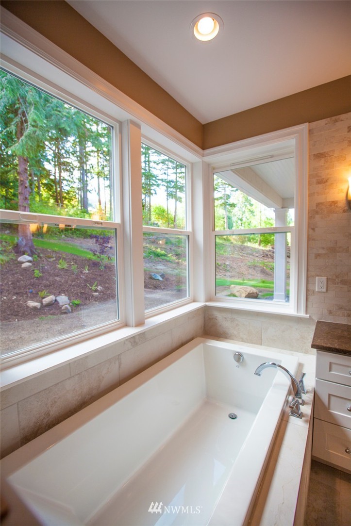 474 Whitecap Road Bellingham, WA 98229 - Photo 12 of 13 a bathroom with a large bathtub and a large window