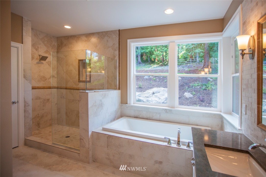 474 Whitecap Road Bellingham, WA 98229 - Photo 13 of 13 a bathroom with a tub shower sink and mirror