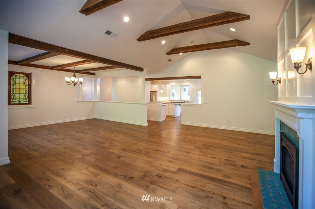474 Whitecap Road Bellingham, WA 98229 - Photo 3 of 13 an empty room with wooden floor and windows