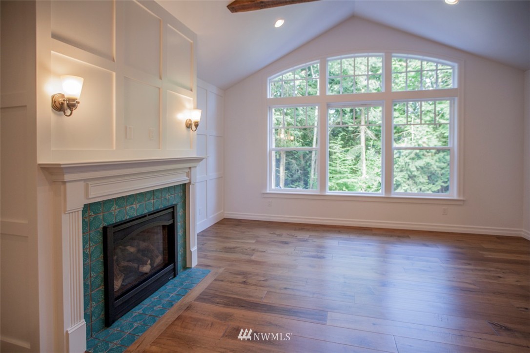 474 Whitecap Road Bellingham, WA 98229 - Photo 6 of 13 a living room with a fireplace with wooden floor