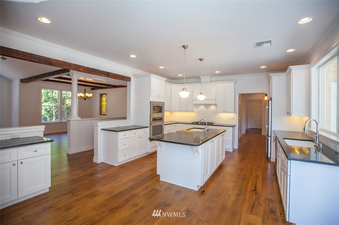 474 Whitecap Road Bellingham, WA 98229 - Photo 7 of 13 a large kitchen with stainless steel appliances kitchen island granite countertop a large counter top and stove