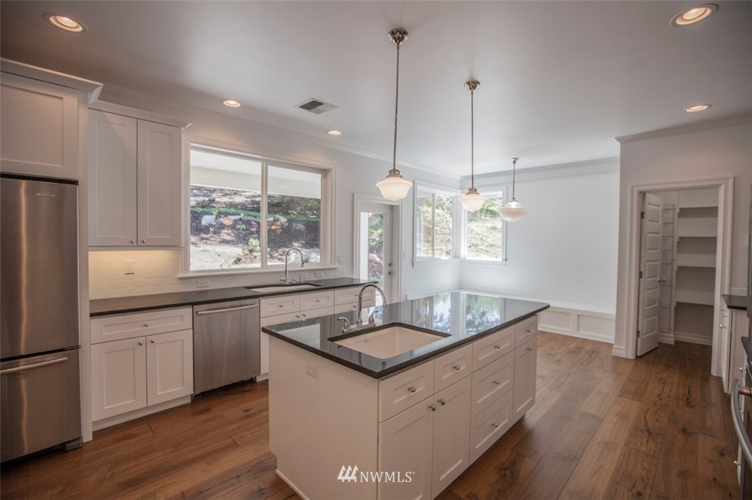 474 Whitecap Road Bellingham, WA 98229 - Photo 9 of 13 a kitchen with granite countertop a sink appliances and wooden floor