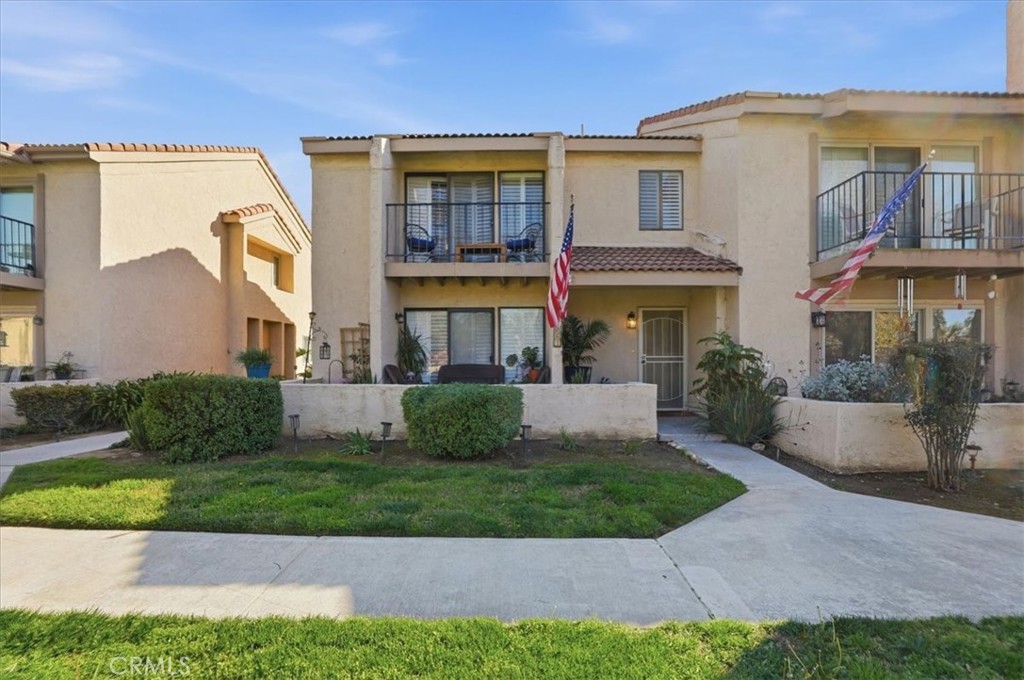 a front view of a residential apartment building with a yard