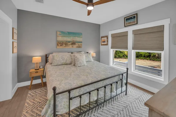 a bathroom with a granite countertop sink a mirror and shower
