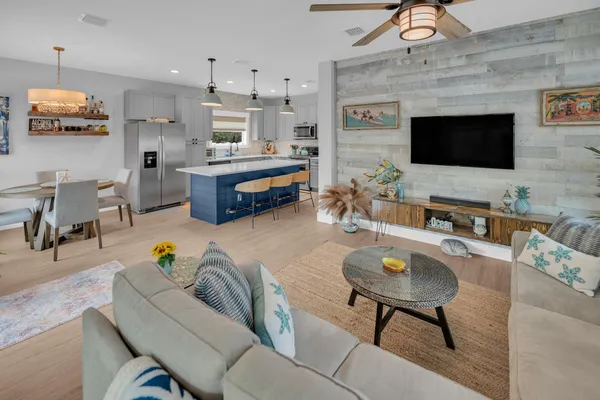 a living room with furniture and wooden floor