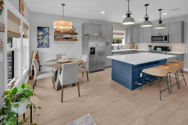 a kitchen with stainless steel appliances granite countertop a sink a stove and a refrigerator