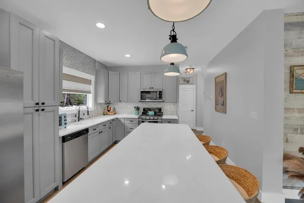 a kitchen with stainless steel appliances a sink stove and cabinets