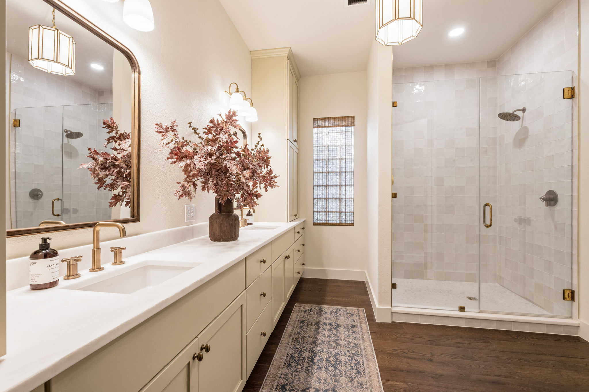 118 Cold Springs Drive Georgetown, TX 78633 - Photo 26 of 40 Dual vanity with pristine countertops and a sleek glass-enclosed shower complement rich hardwood flooring.