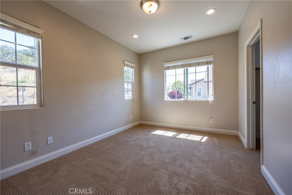 9369 Riberena Circle Atascadero, CA 93422 - Photo 32 of 48 Bedroom 2 has plush carpet and multiple windows.