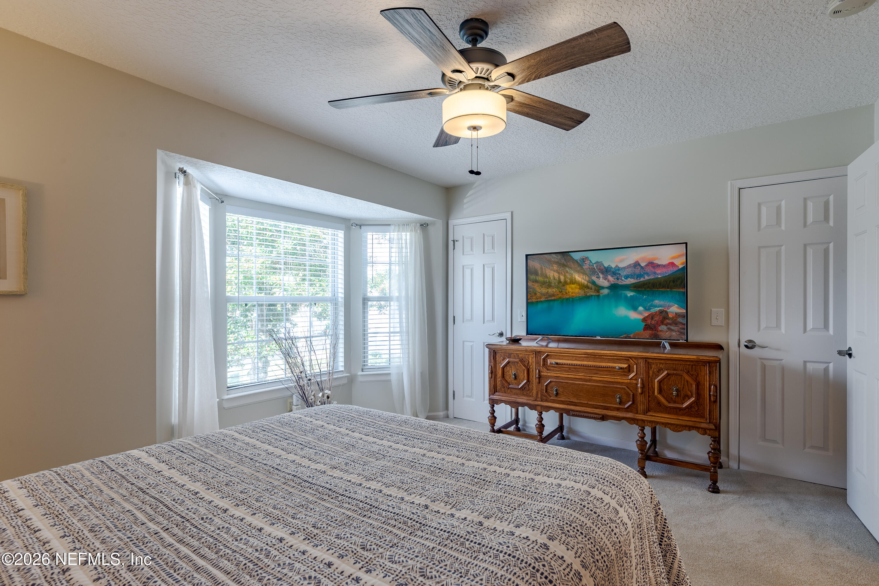 3327 Lighthouse Point Lane Jacksonville, FL 32250 - Photo 13 of 56 a bedroom with a bed dresser and a window