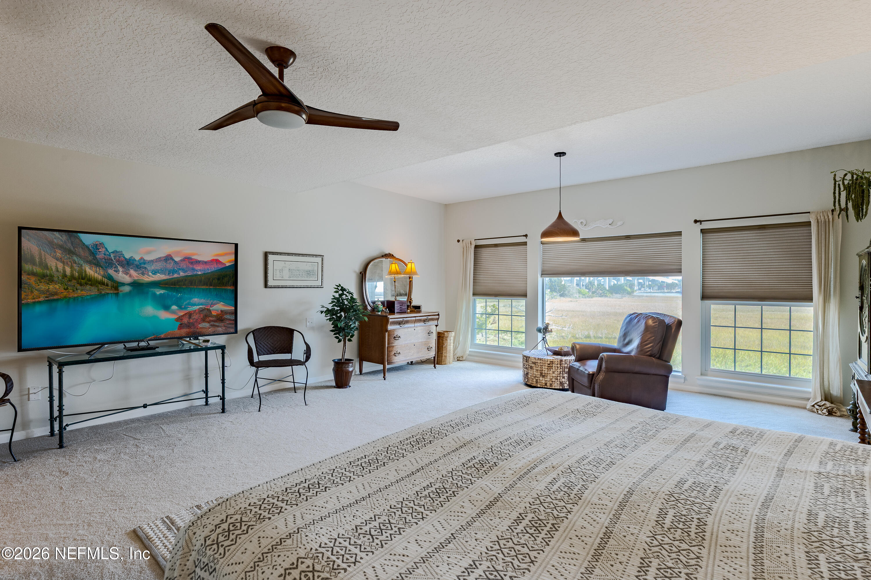 3327 Lighthouse Point Lane Jacksonville, FL 32250 - Photo 22 of 56 a bed room with furniture and a flat screen tv