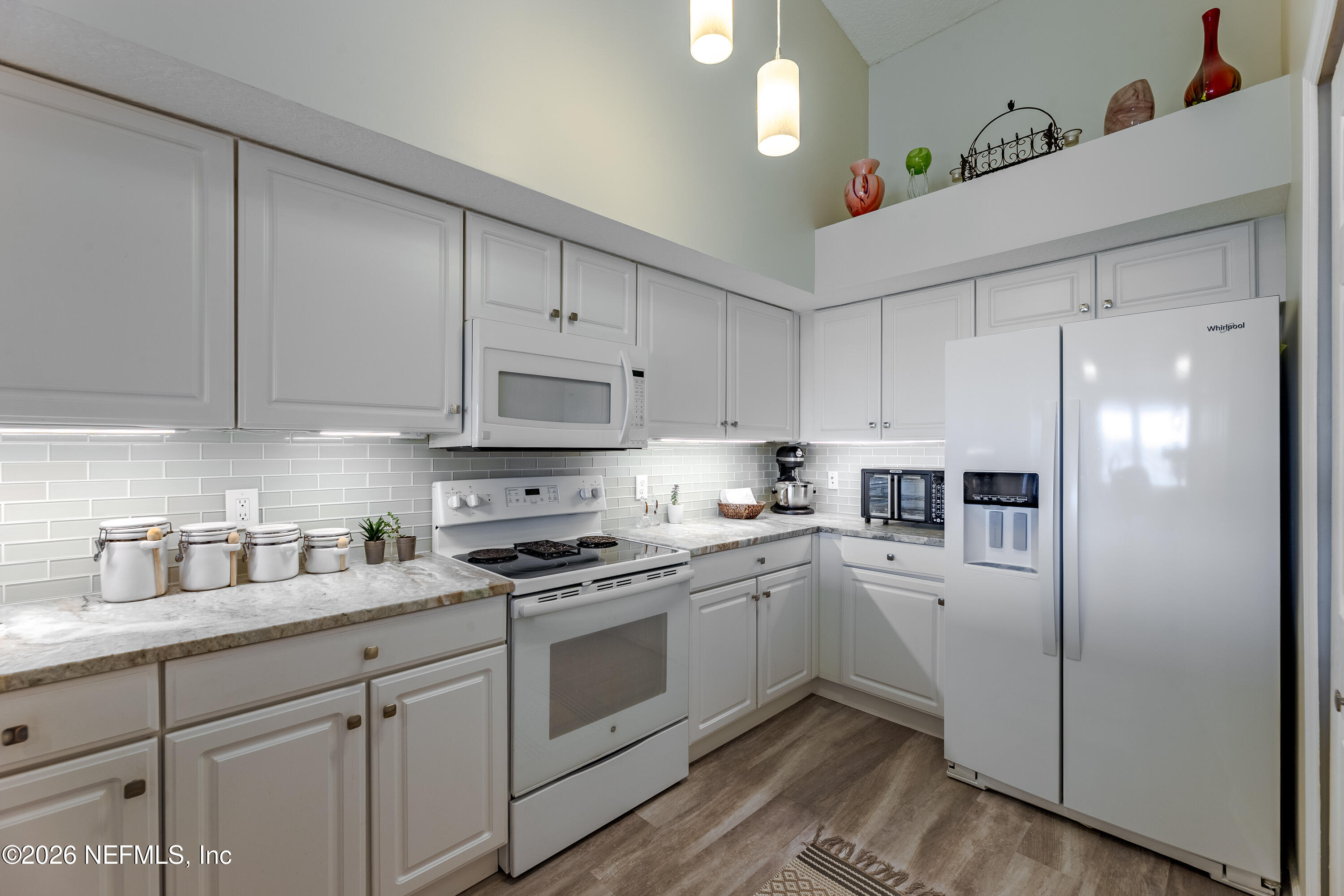 3327 Lighthouse Point Lane Jacksonville, FL 32250 - Photo 24 of 56 a kitchen with cabinets stainless steel appliances and a sink